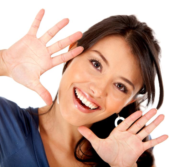 A smiling woman doing jazz hands | dentistry in Wilmington, DE