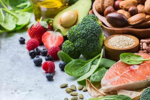A table of assorted fruits, nuts, and vegetables