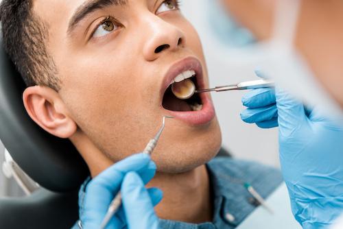 A man getting a dental exam in Wilmington