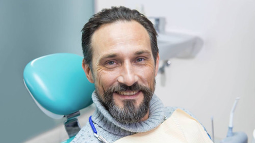 older man sitting in dentist exam chair in wilmington de