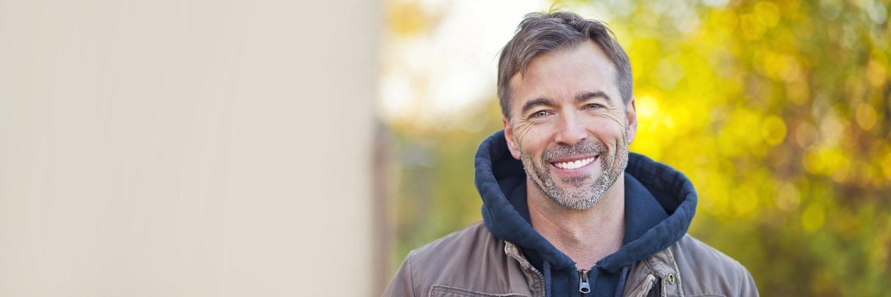 man with facial hair smiling | dentist wilmington