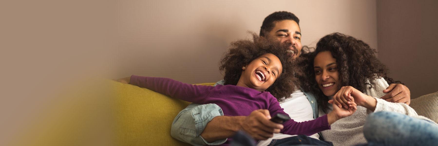 family of three hugging on couch | pediatric dentistry pike creek