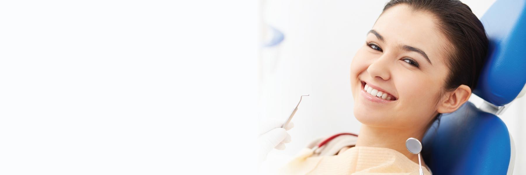 Woman sitting in dental chair l pike creek de dentist