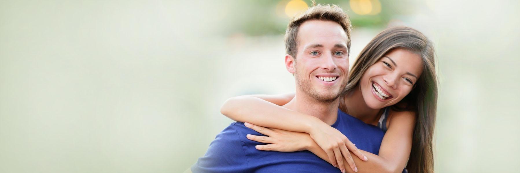 Young couple laughing & smiling l Dentist Pike Creek DE