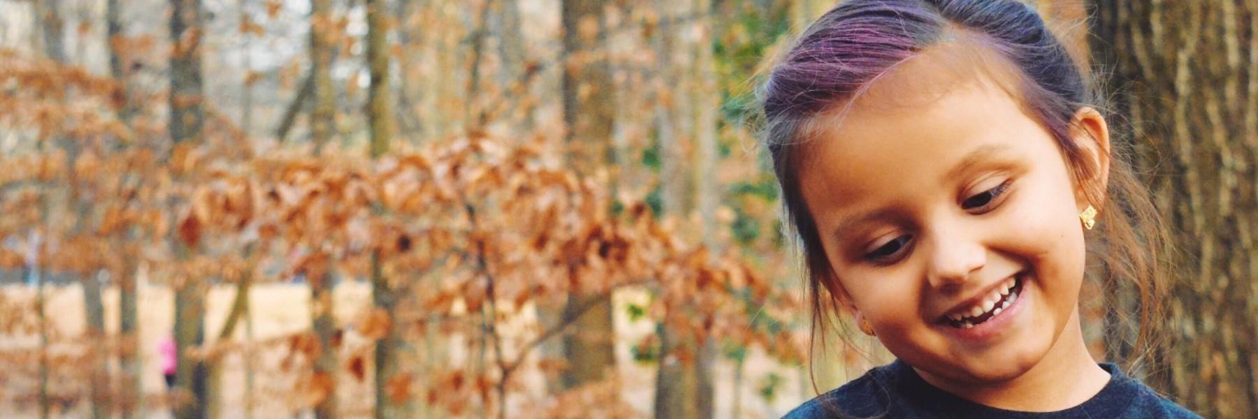 young girl with purple hair smiling l pediatric dentist wilmington