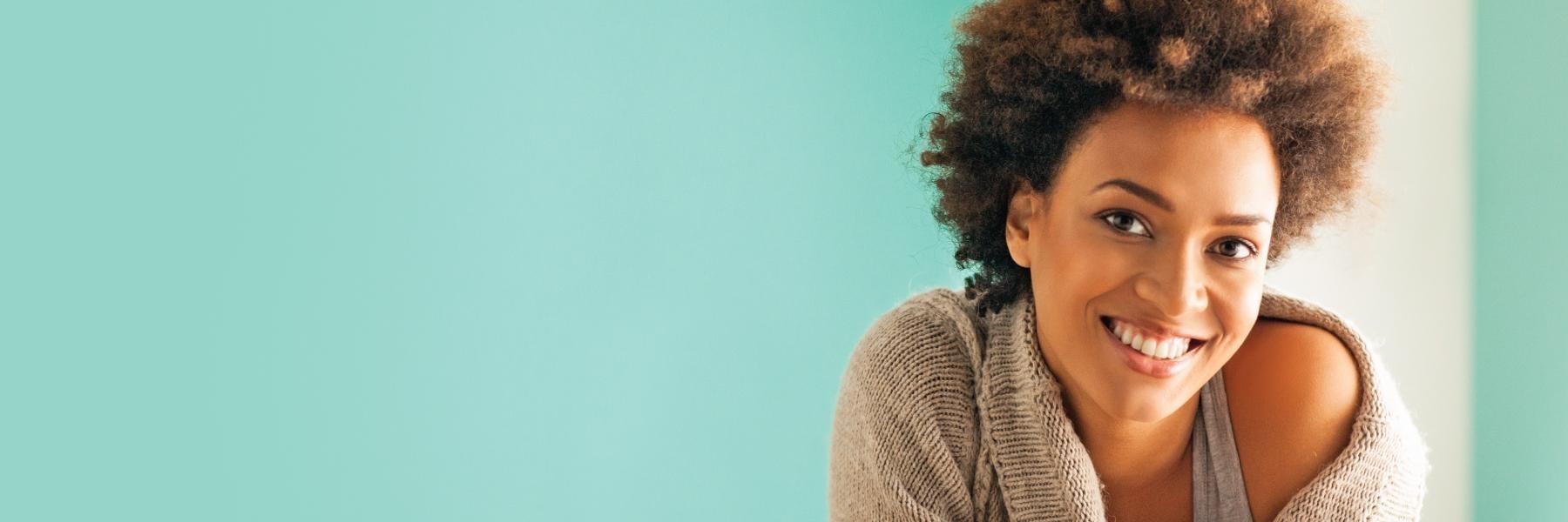 woman with curly hair smiling l dentist near me