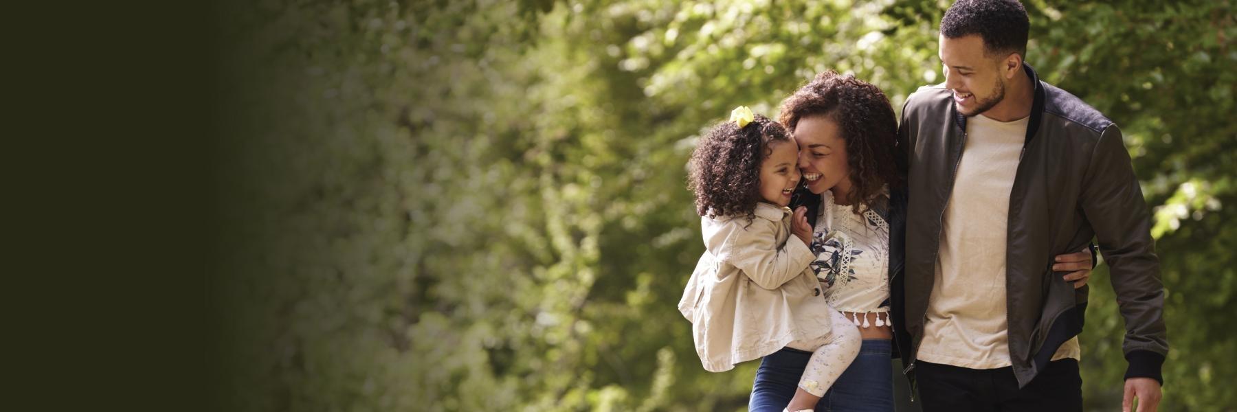 A family smiling while on a walk