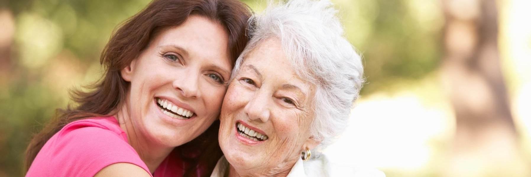 older woman & younger woman smiling l dental implants wilmington