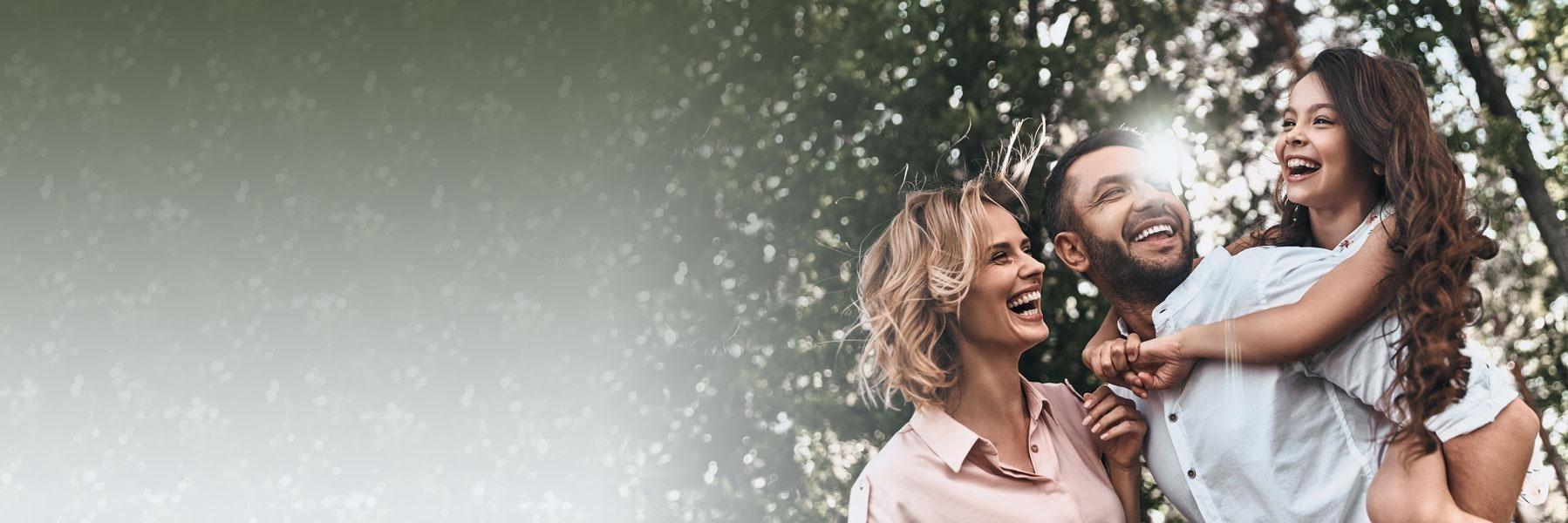 young couple smiling outside | dental crowns wilmington de
