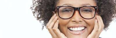 A smiling woman with glasses on a white background