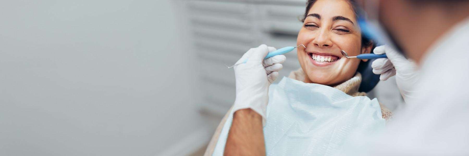 A smiling woman getting a dental exam 