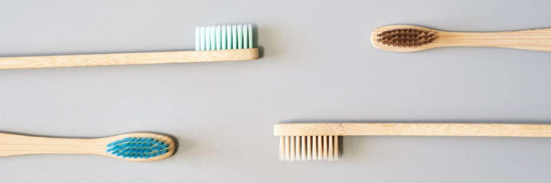 four different colored toothbrushes | cosmetic dentist wilmington de