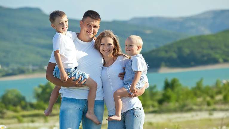 A smiling family at the lake