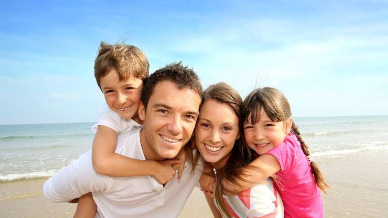 A smiling family on the beach
