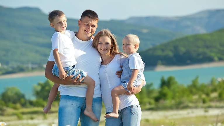 A family with two children by the lake | family dentist Wilmington