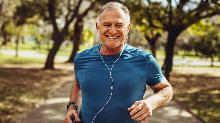 A man running outdoors smiling | dentist Wilmington DE