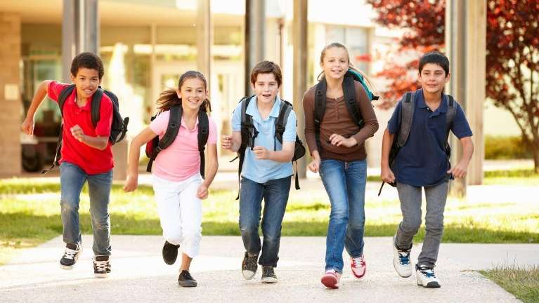 A group of children racing to school | pediatric dentistry