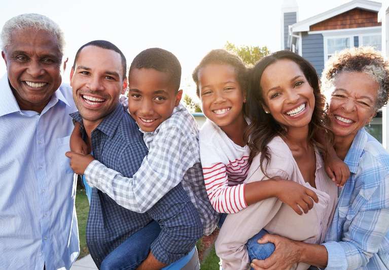 A smiling family in their backyard | dentist wilmington