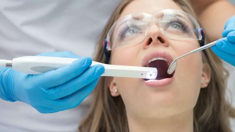 A patient receiving laser dentistry