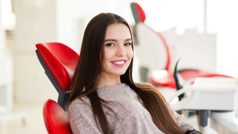 A woman sitting in a dentist's office | dentist Wilmington DE