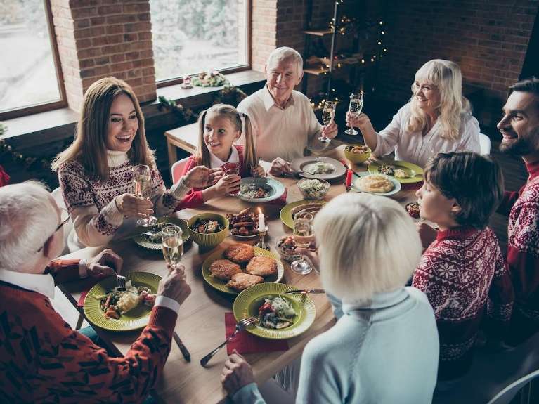 A family eating a holiday meal around a table