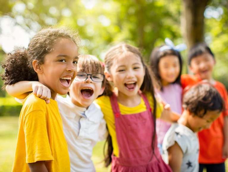 A group of laughing children outside