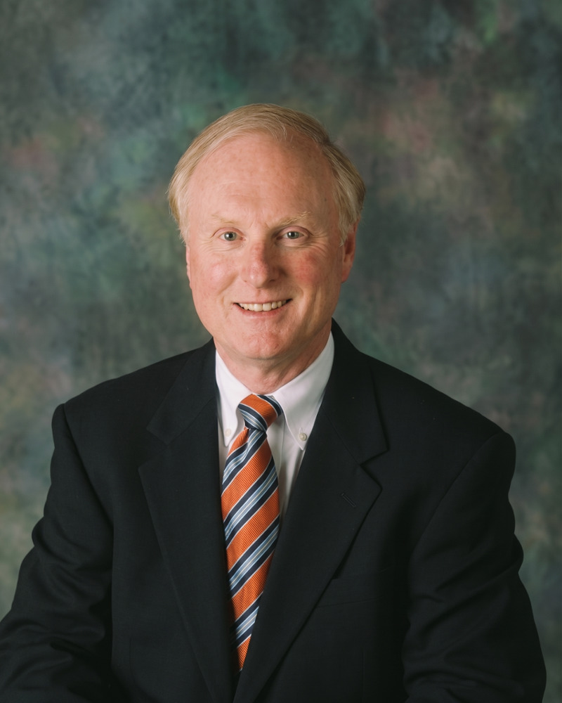 Dr. Mark Gladnick, experienced family dentist, smiling professionally in suit and tie portrait